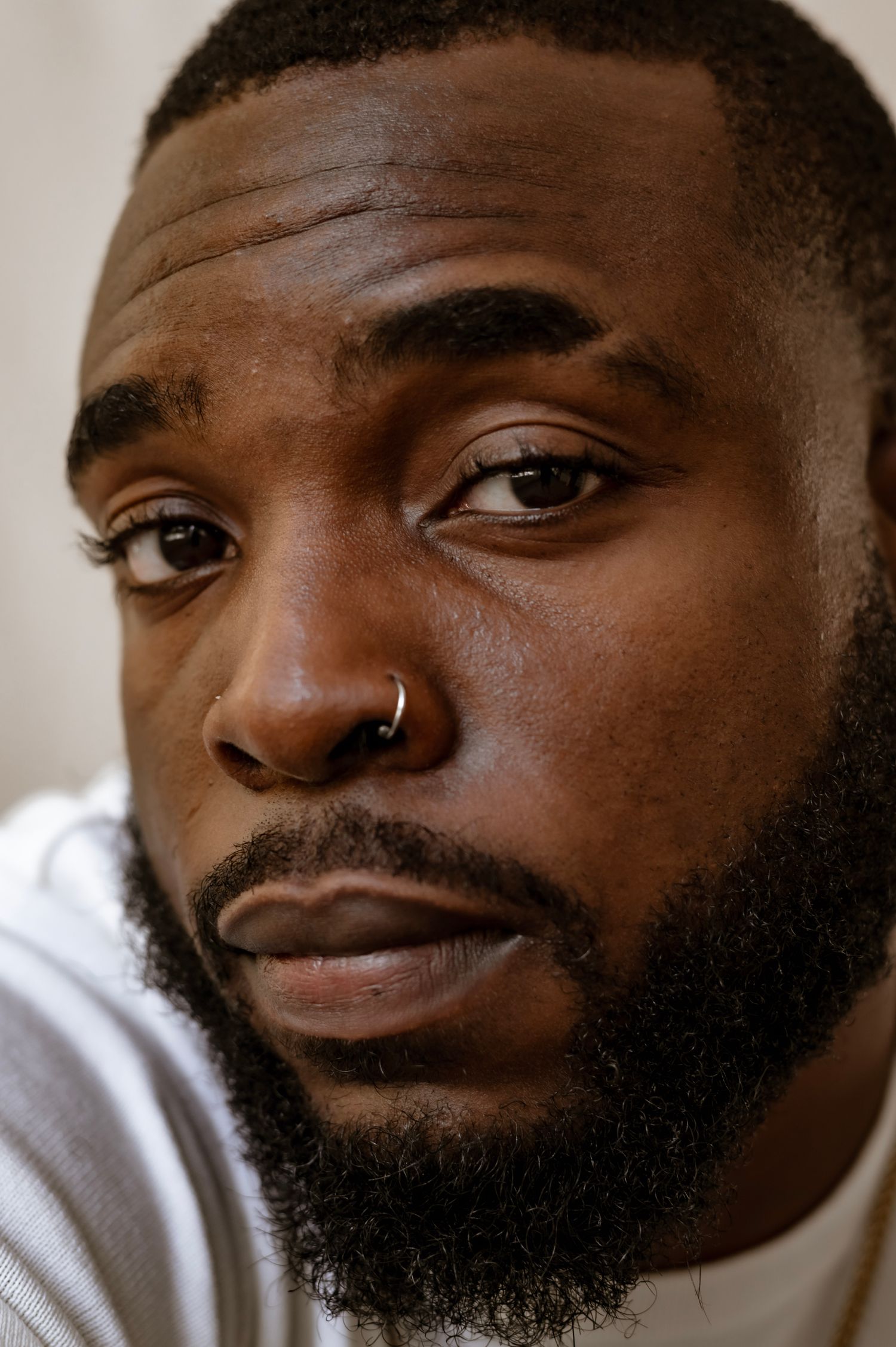 Editorial portrait of a sharply groomed man with a precise beard, the GQ Cutz cover